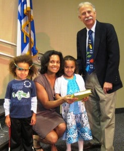 First grader Aytana Anthony (holding siddur) and family with Cantor David Proser