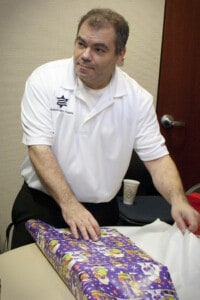 Jason Capossere wraps the gifts.