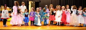 HAT and Strelitz preschool students join on stage in a parade of Purim costumes.