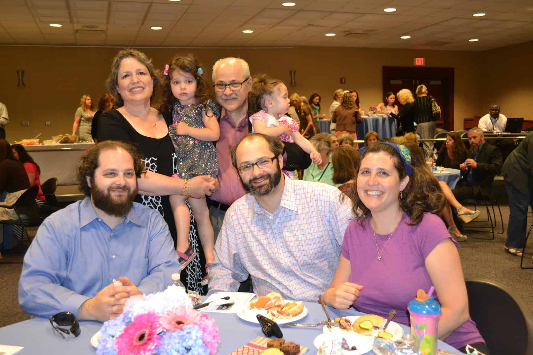 Alene Jo Kaufman (holding granddaughter, Maya), husband Ron Kaufman (holding granddaughter Lillian), and (seated) sons Adam and Jason Kaufman, and daughter-in-law Jessica Kaufman at the brunch.