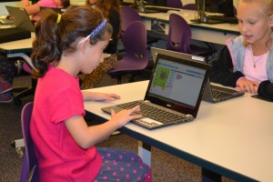 HAT student Emily Leon solves a coding problem by manipulating blocks.