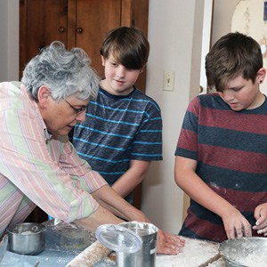 Sheryl Luebke and twins John and Peyton Rchardsonprepare the dough for Hamantashen.
