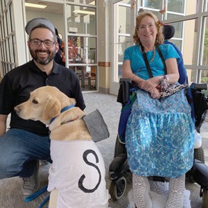 Director of Recreational Therapy Josh Bennett, service dog Yanni, and Pat Jankosky.
