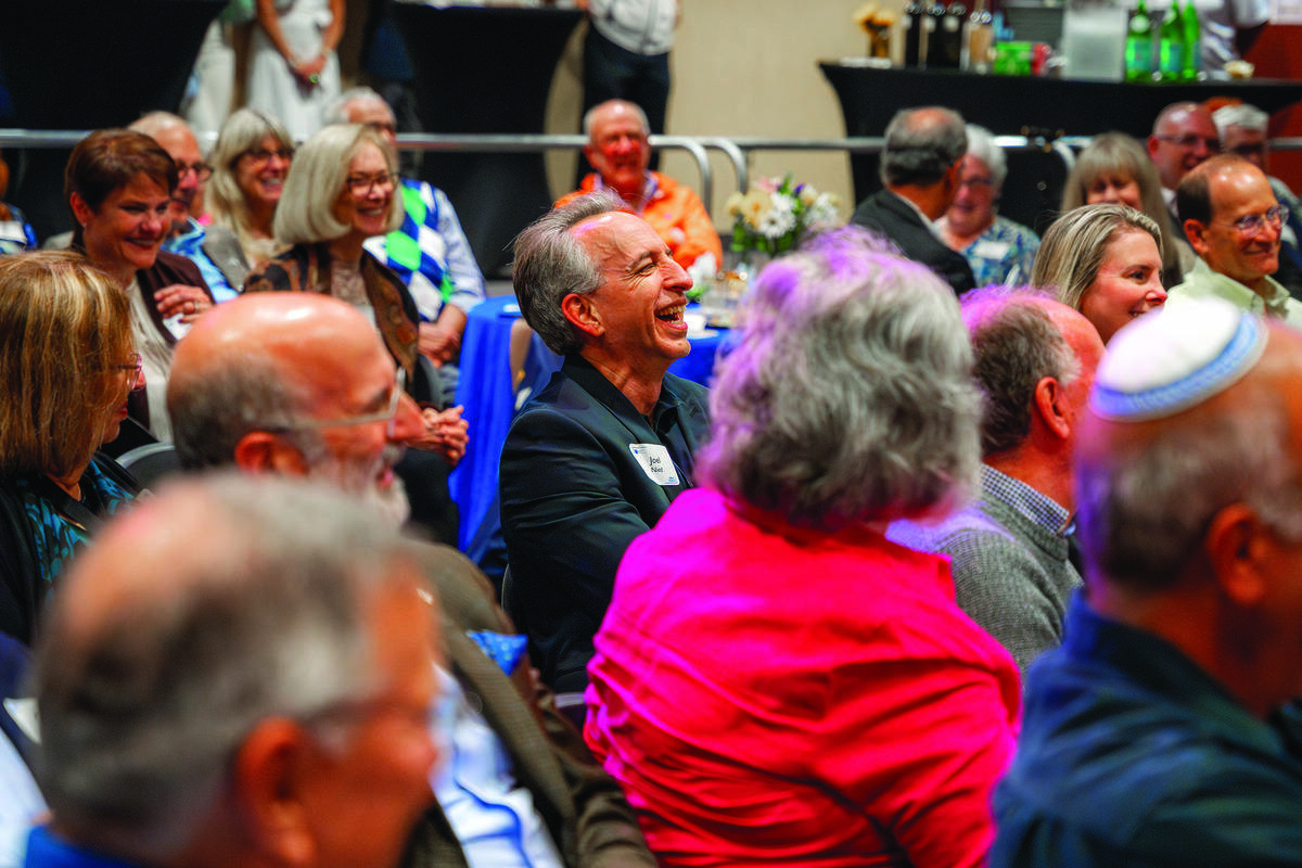 Joel Nied (center) laughs at Joel Chasnoff’s comedy.