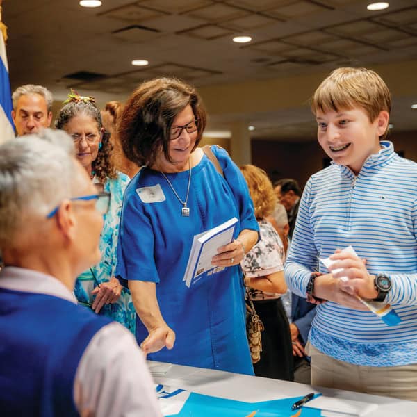 Joel Chasnoff greets Gina Rose and Randall Nied.