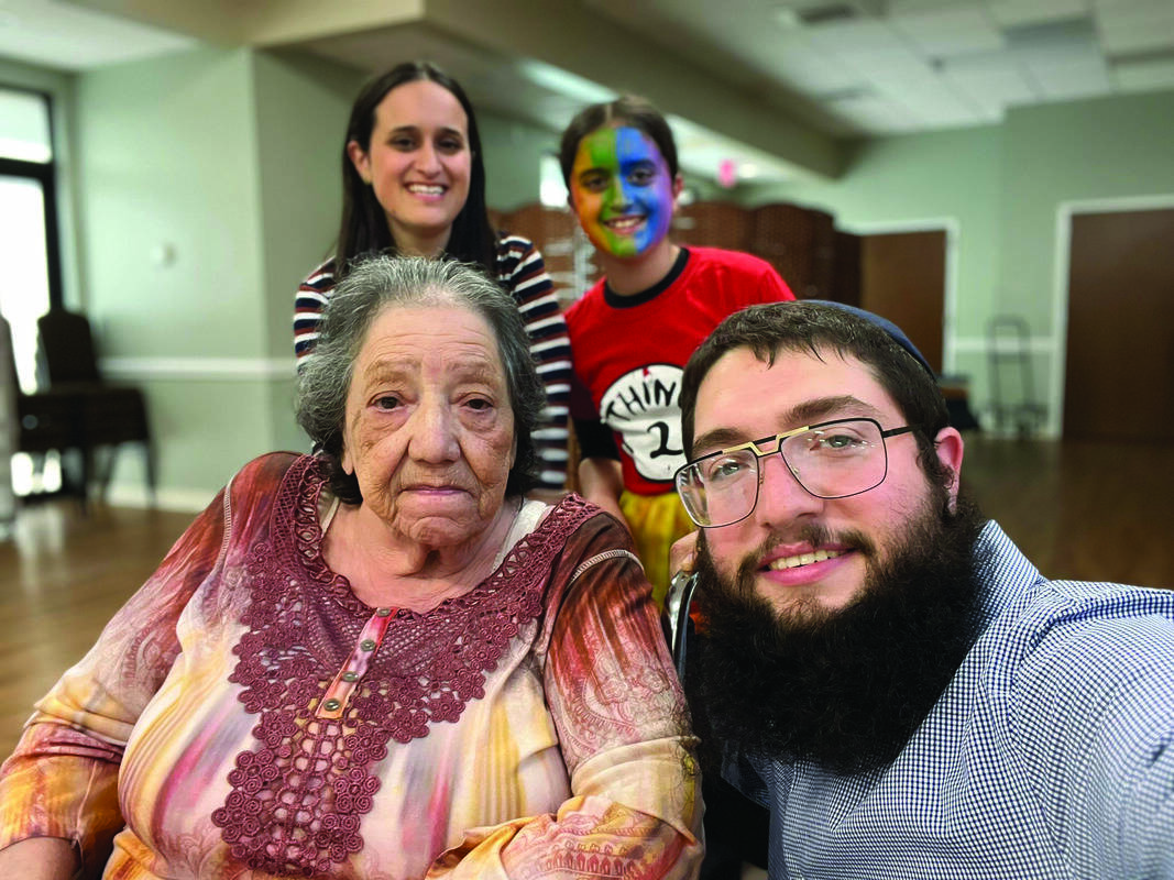 Kayla Weinreb, Sari Weinreb, Resident Mery Ann, and Rabbi Meir Lessoff.