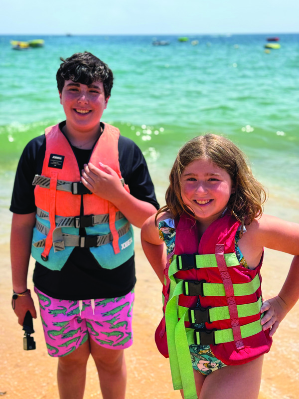 Zachary and Abigail Cohen on beach in Albufeira, Portugal about to go parasailing for the first time. 
