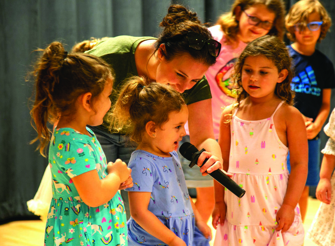 Emilia St. Pierre leads the group in song.