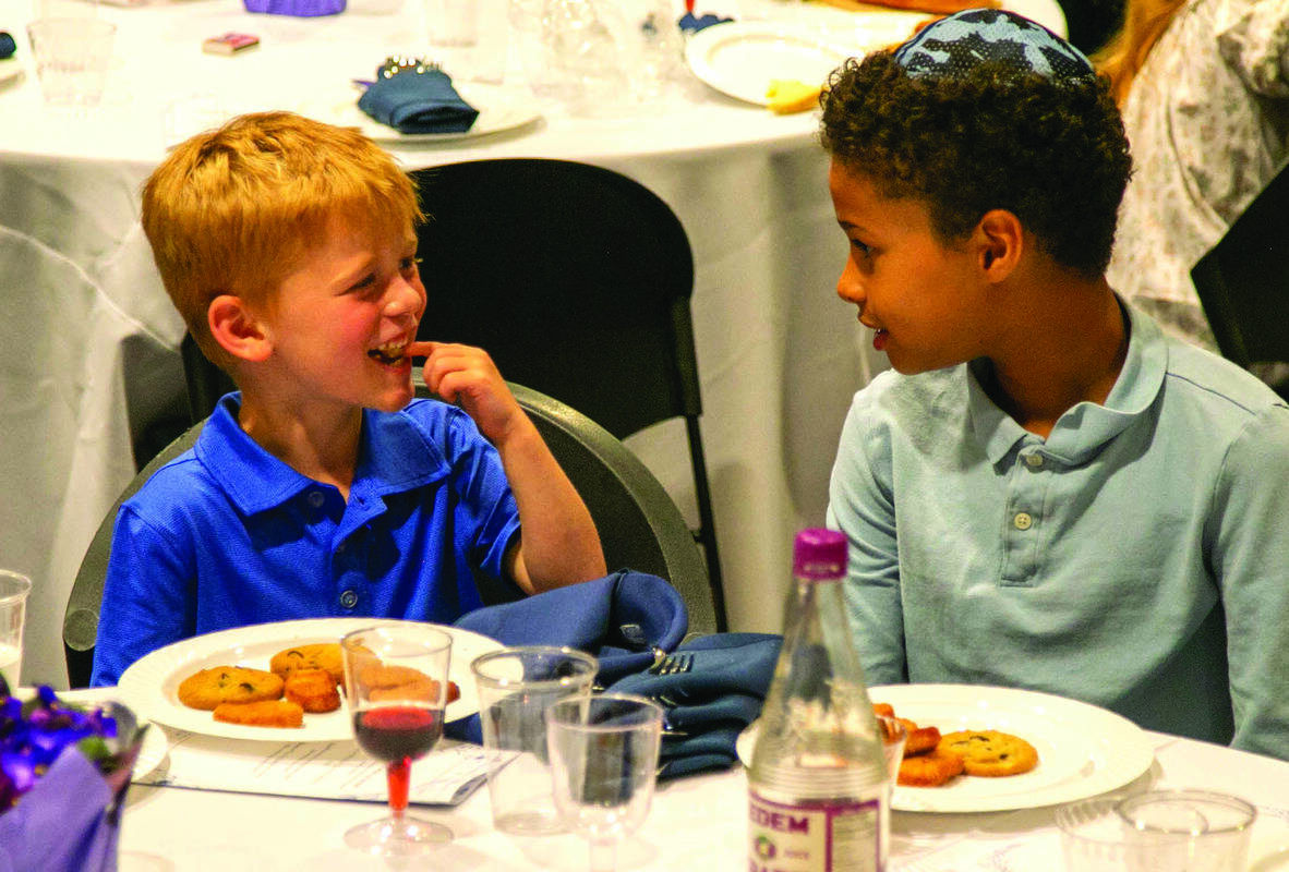 Shai Rubin and Jackson Gordon enjoy Shabbat dinner.