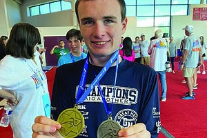 Oliver Scolnick wears two of his many medals.