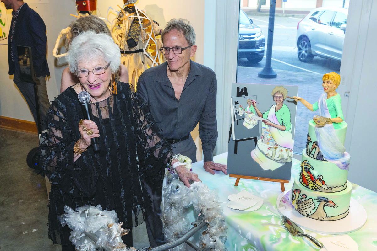 Lorraine Fink with her son, Edward, prepares to cut the cake at her birthday celebration.