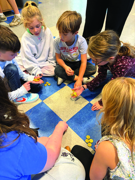 With gelt on the line, campers engage in an intense game of dreidel: Zeeva Cooper, Killian Bickerton, Izzy Ford, Simon Fine, Lily Bertani, and Juliette Fine. 