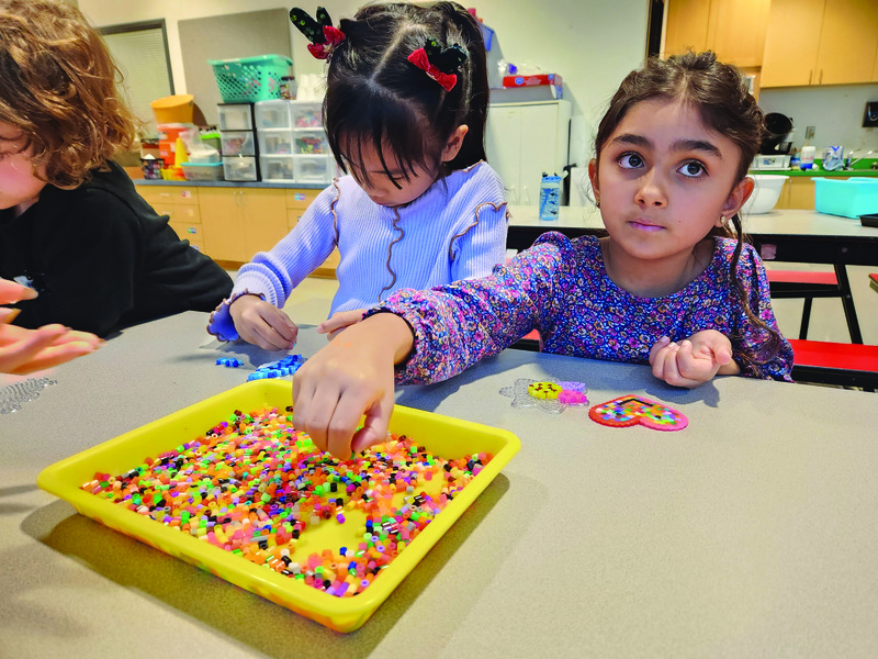 Campers enjoy a camp classic, fuse beads: Ann Ning and Jolie Wilson. 