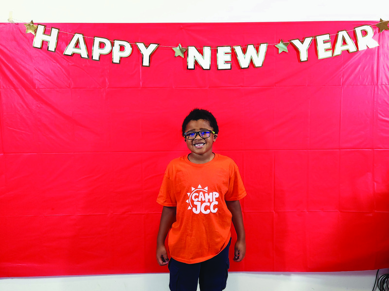 Malex Monk poses in his Camp JCC swag in the New Year’s Noon photo booth.