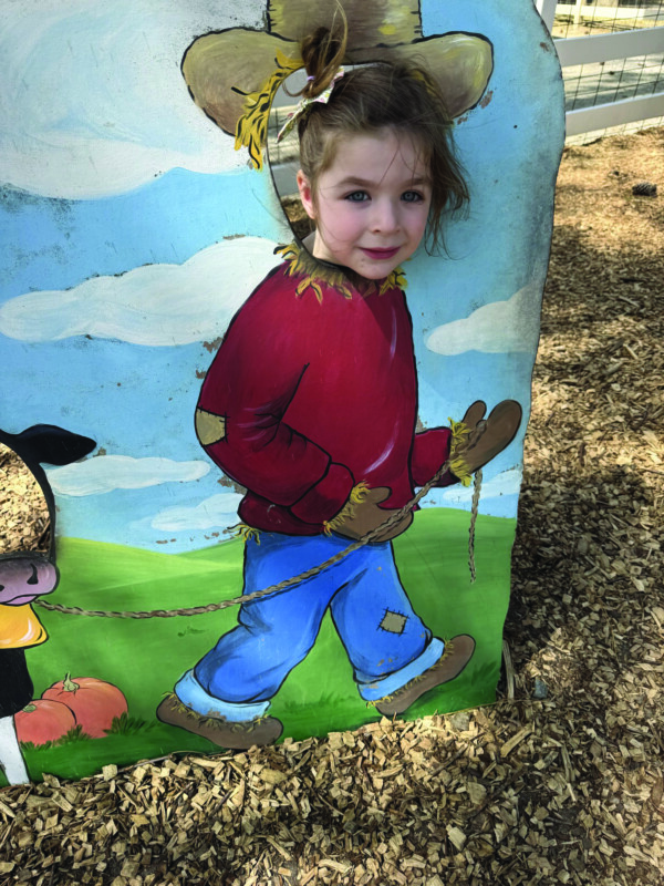 Mollie Glassman poses as a scarecrow.