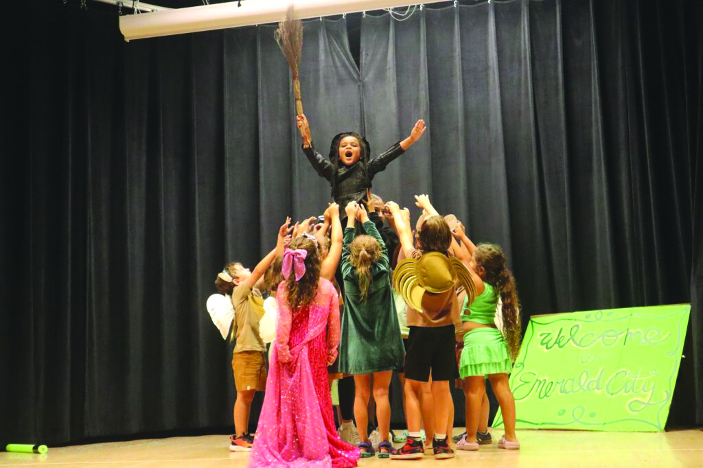  Tiberias goes Wicked in the finale of their lip sync performance. Isabella Brent is raised high as Elphaba in Emerald City. 
