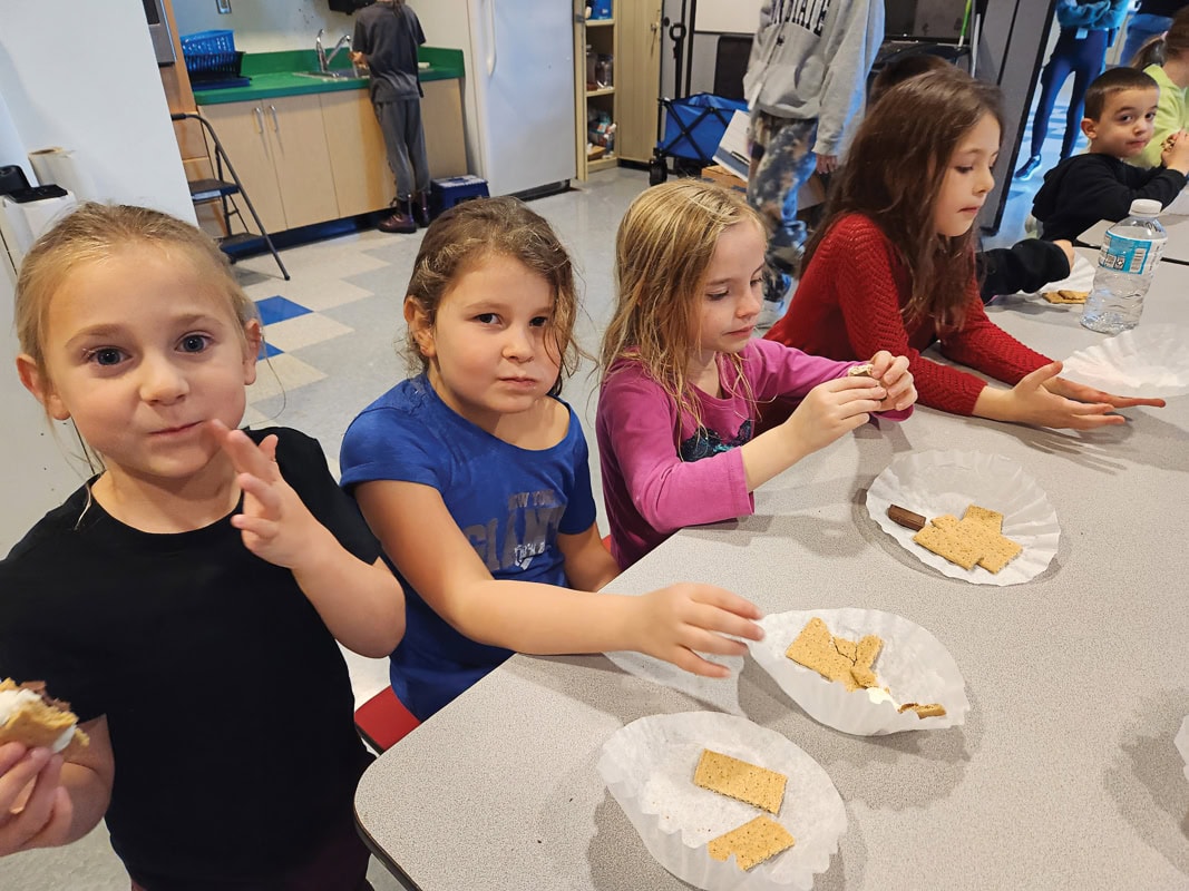Who said that you can’t have s’mores in the wintertime? Theo Trem, Ruby Kievit, Corah Beasley, Zara Murdock, and Simon Shall.