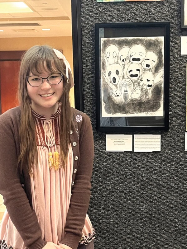 Alice Parker Hall beside her artwork, Pain Can't Be Erased.