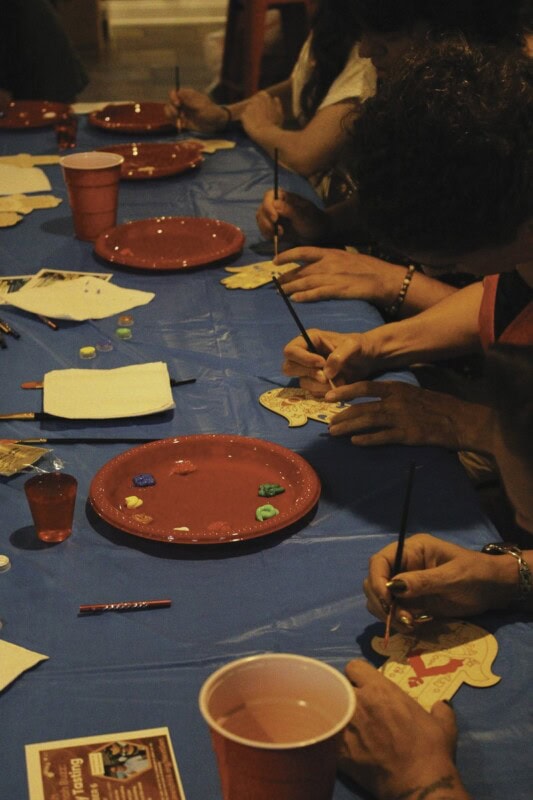 Painting Hamsa door decorations.