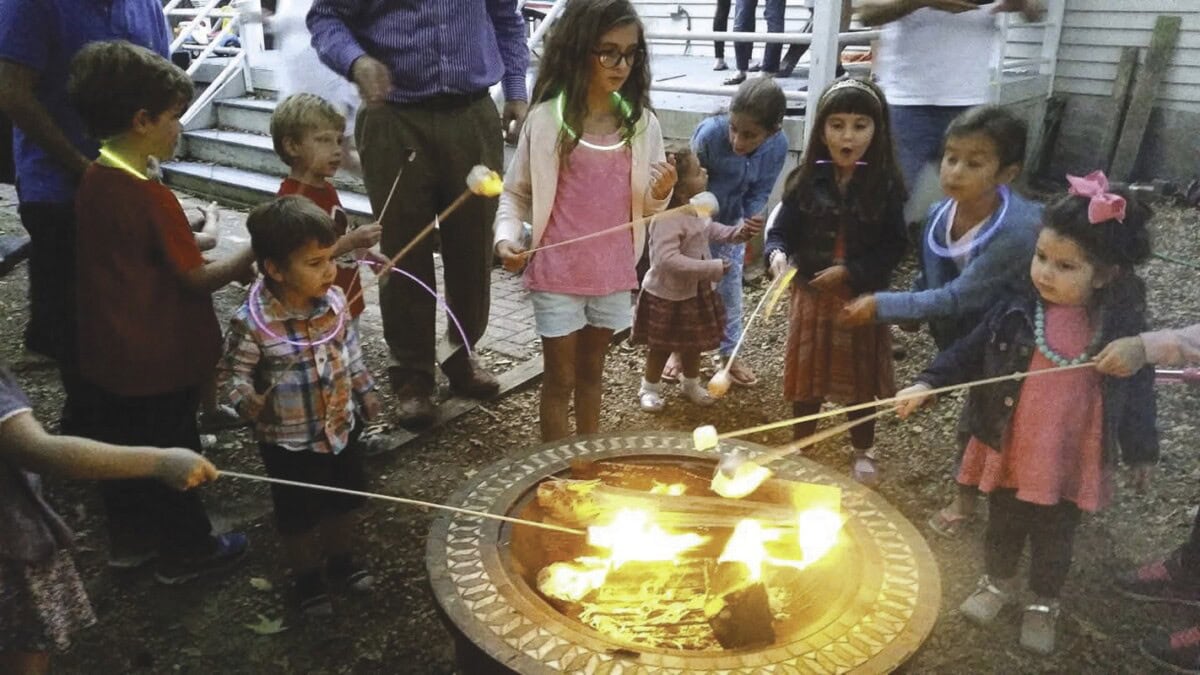 Roasting marshmallows for s’mores at the Weinsteins’ Break Fast.