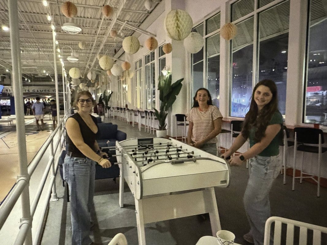 Hattie Friedman, Esther Barkan, and Dalia Portnoy play foosball at Beachside Social.