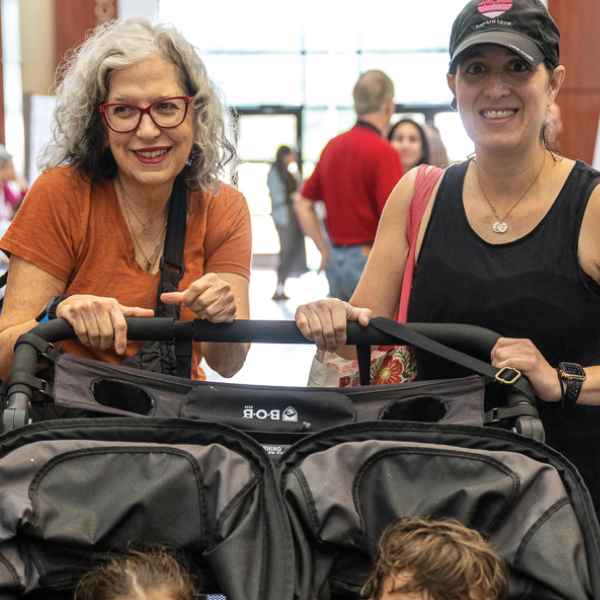 Families enjoy Agency Impact Fair.