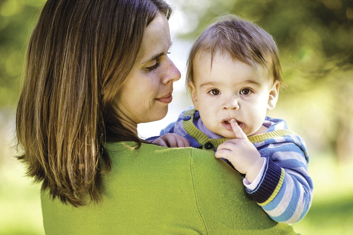 bigstock-Mother-holding-little-son-in-h-121689281